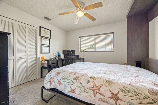132 SW 34th Ln, Cape Coral, FL 33914 - bedroom featuring light carpet, a closet, a desk, a textured ceiling, and a ceiling fan