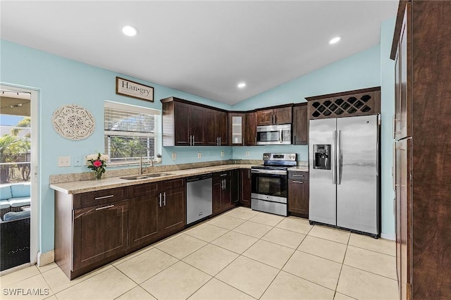 1233 NW 26th Pl, Cape Coral, FL 33993 - kitchen featuring stainless steel appliances, a sink, light countertops, dark brown cabinetry, and lofted ceiling