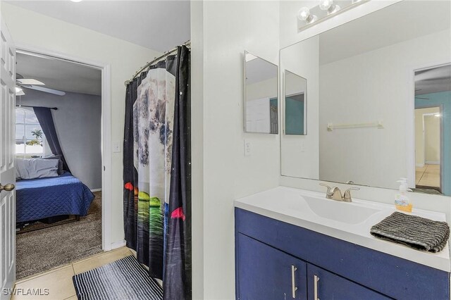 1233 NW 26th Pl, Cape Coral, FL 33993 - full bathroom featuring ceiling fan, ensuite bath, tile patterned flooring, and vanity