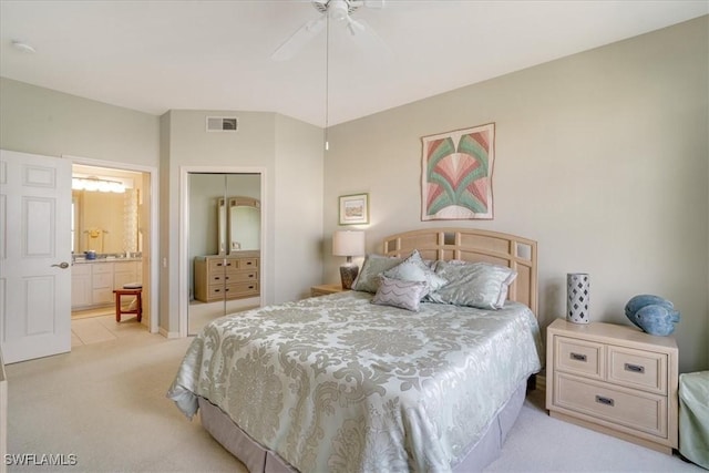17040 Willowcrest Way Unit 209, Fort Myers, FL 33908 - bedroom with light colored carpet, a closet, connected bathroom, and a ceiling fan