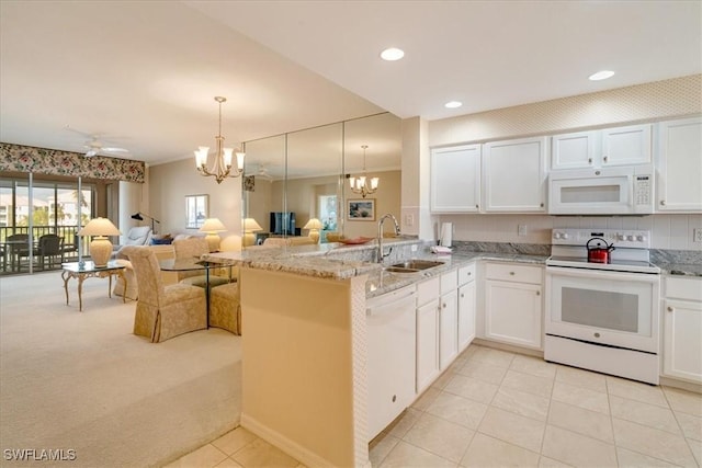 17040 Willowcrest Way Unit 209, Fort Myers, FL 33908 - kitchen with white appliances, a chandelier, a sink, light colored carpet, and open floor plan