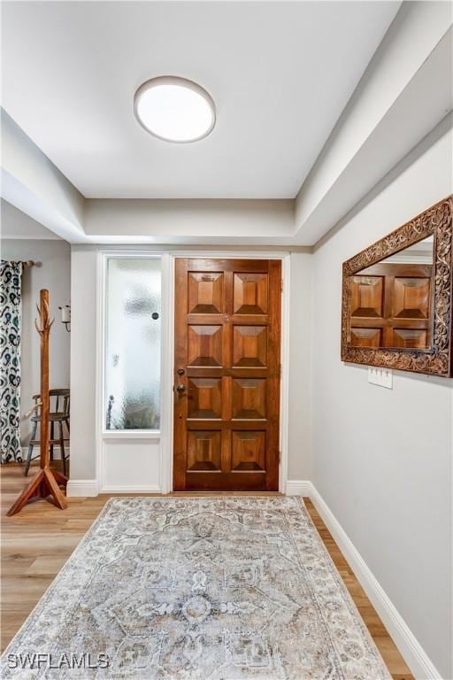 5692 Eichen Cir W, Fort Myers, FL 33919 - foyer entrance featuring light wood-type flooring and baseboards