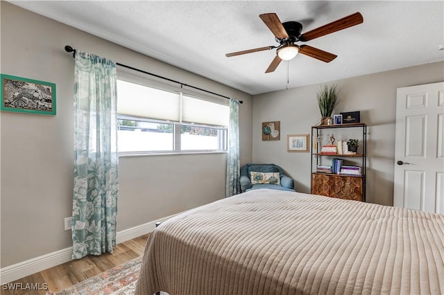 5692 Eichen Cir W, Fort Myers, FL 33919 - bedroom with light wood finished floors, baseboards, and a ceiling fan