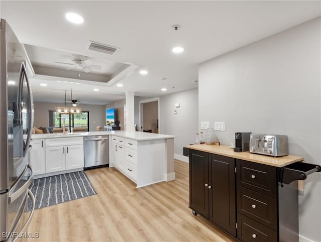16200 Kelly Cove Dr Unit 208, Fort Myers, FL 33908 - kitchen with stainless steel appliances, light countertops, light wood-type flooring, white cabinets, and ceiling fan