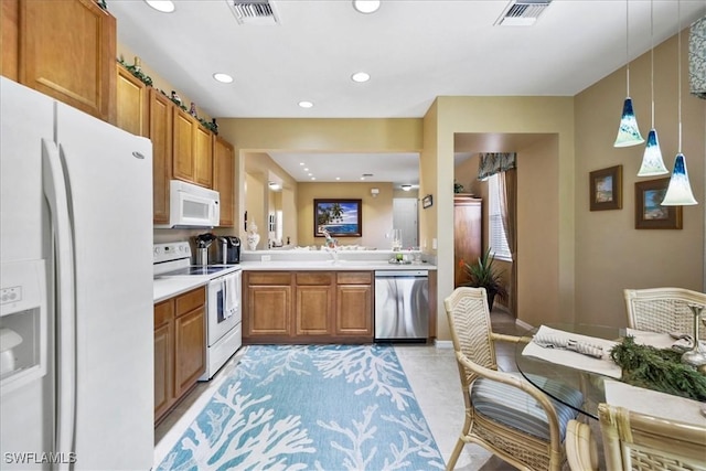 13180 SW Pembroke Cir, Lake Suzy, FL 34269 - kitchen with white appliances, light countertops, recessed lighting, brown cabinetry, and hanging light fixtures