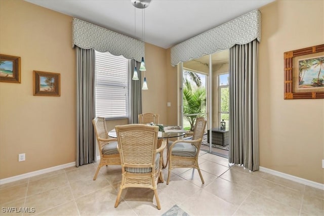 13180 SW Pembroke Cir, Lake Suzy, FL 34269 - dining space with baseboards and light tile patterned flooring