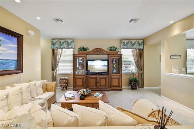 13180 SW Pembroke Cir, Lake Suzy, FL 34269 - living room featuring carpet floors, baseboards, and recessed lighting