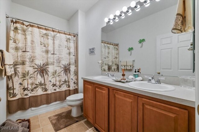 13180 SW Pembroke Cir, Lake Suzy, FL 34269 - full bath with tile patterned flooring, toilet, double vanity, and shower / tub combo