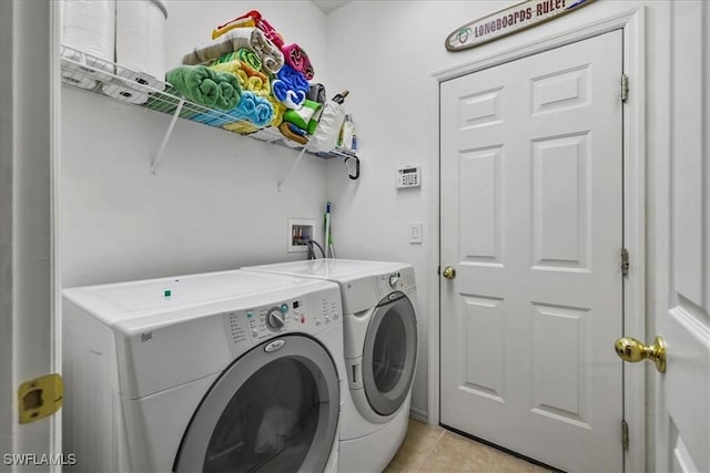 13180 SW Pembroke Cir, Lake Suzy, FL 34269 - washroom with washing machine and clothes dryer and light tile patterned floors