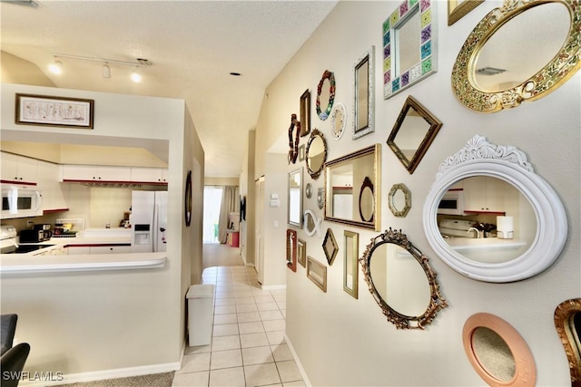 161 Wading Bird Cir Unit L202, Naples, FL 34110 - corridor with light tile patterned floors and baseboards