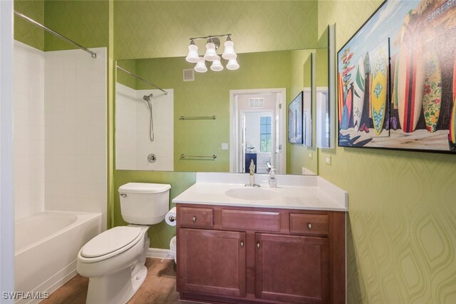 11741 Pasetto Ln Unit 403, Fort Myers, FL 33908 - full bathroom with wallpapered walls, toilet, shower / washtub combination, vanity, and a chandelier