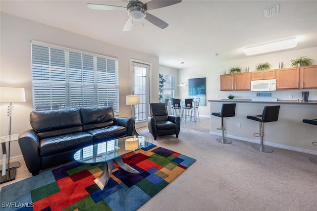 11741 Pasetto Ln Unit 403, Fort Myers, FL 33908 - living room featuring ceiling fan, light colored carpet, and baseboards