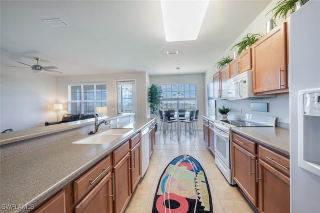 11741 Pasetto Ln Unit 403, Fort Myers, FL 33908 - kitchen featuring white appliances, a sink, light tile patterned floors, a ceiling fan, and brown cabinets