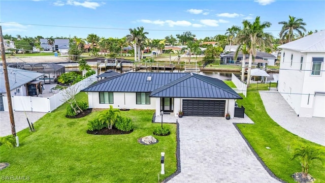 6212 Cocos Dr, Fort Myers, FL 33908 - view of front of house with a standing seam roof, a garage, metal roof, a residential view, and decorative driveway