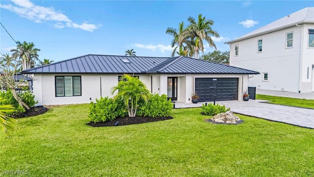 6212 Cocos Dr, Fort Myers, FL 33908 - view of front of property featuring a standing seam roof, a garage, a front lawn, decorative driveway, and metal roof