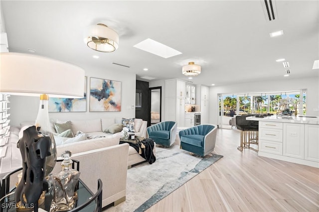 6212 Cocos Dr, Fort Myers, FL 33908 - living room featuring a skylight, light wood-type flooring, recessed lighting, and beverage cooler