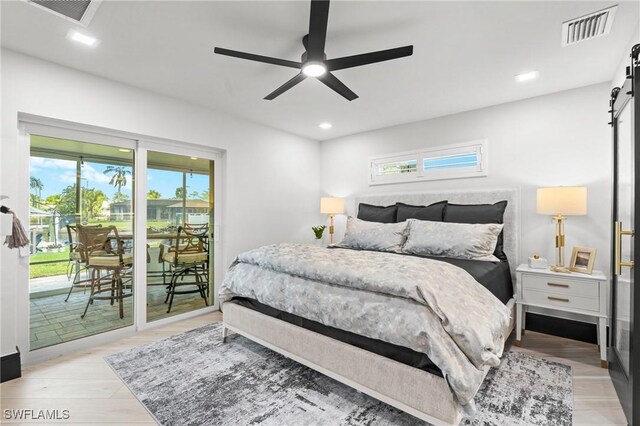 6212 Cocos Dr, Fort Myers, FL 33908 - bedroom featuring access to outside, a barn door, light wood-type flooring, recessed lighting, and ceiling fan