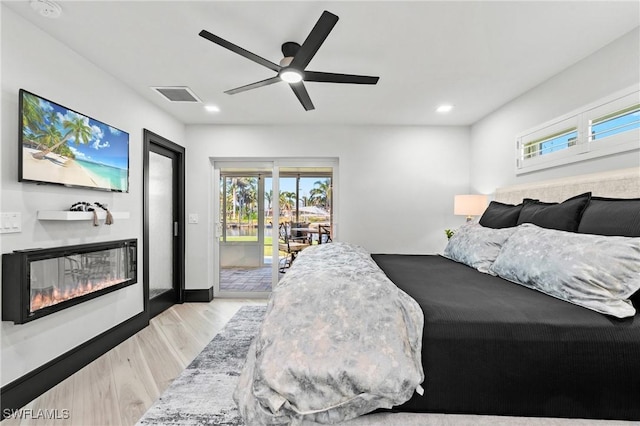 6212 Cocos Dr, Fort Myers, FL 33908 - bedroom featuring access to outside, a glass covered fireplace, wood finished floors, recessed lighting, and a ceiling fan
