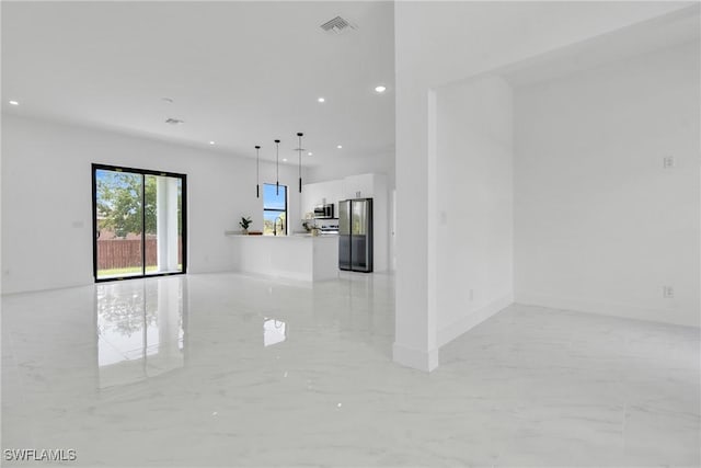 2003 Curry Ave N, Lehigh Acres, FL 33971 - unfurnished living room featuring light marble finish floors and recessed lighting