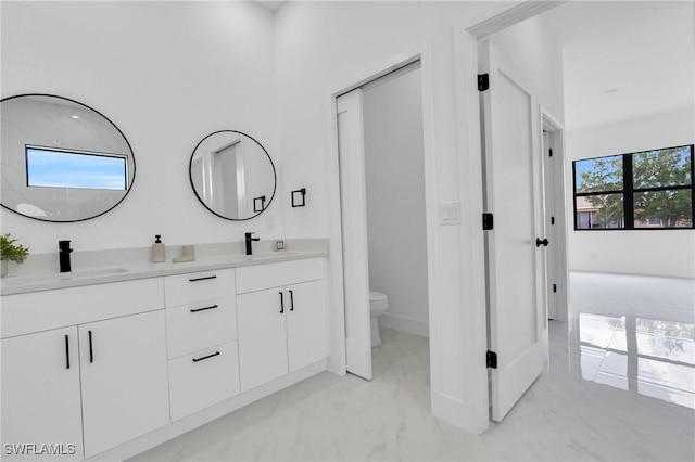 2003 Curry Ave N, Lehigh Acres, FL 33971 - bathroom featuring double vanity, marble look tile flooring, and toilet