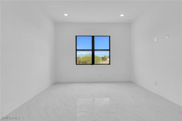 2003 Curry Ave N, Lehigh Acres, FL 33971 - empty room with baseboards, light marble finish flooring, and recessed lighting