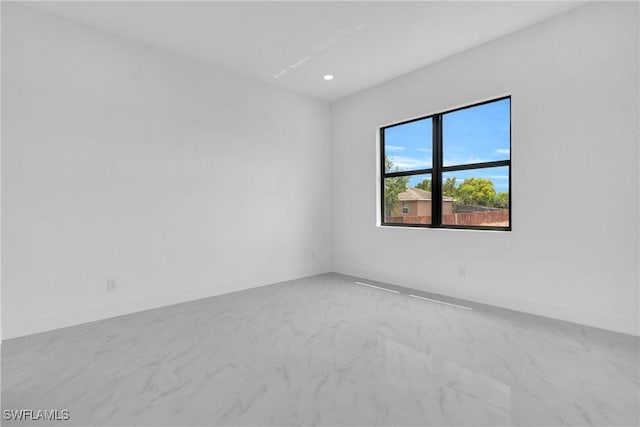 2003 Curry Ave N, Lehigh Acres, FL 33971 - empty room featuring marble finish flooring, recessed lighting, and baseboards