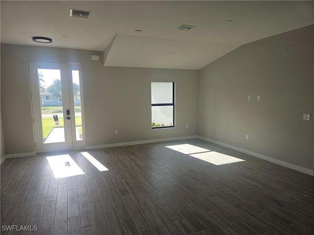 27584 Playa Del Rey Ln, Bonita Springs, FL 34135 - empty room featuring healthy amount of natural light, dark wood-style floors, and vaulted ceiling