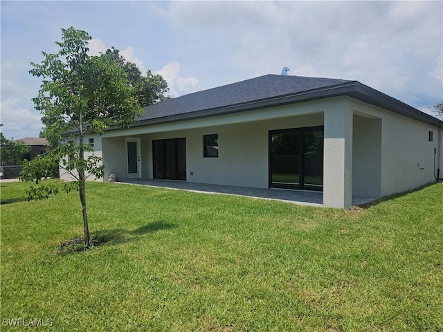 27584 Playa Del Rey Ln, Bonita Springs, FL 34135 - rear view of property with a lawn, stucco siding, and a patio