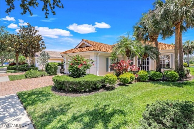 3774 Whidbey Way, Naples, FL 34119 - mediterranean / spanish-style home with a tile roof, a front yard, stucco siding, and a garage