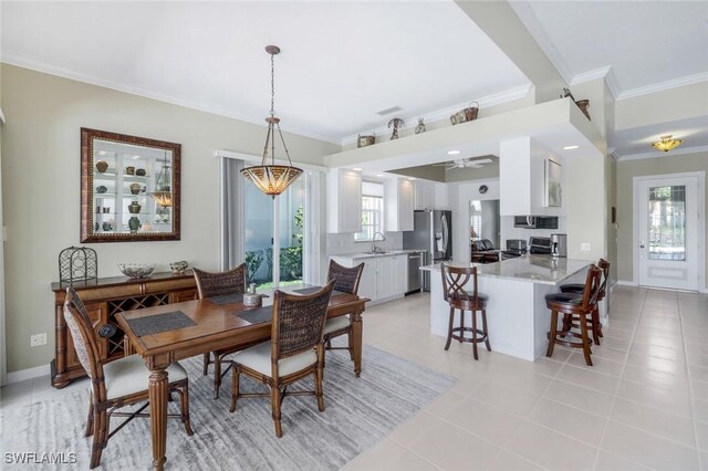 3774 Whidbey Way, Naples, FL 34119 - dining space featuring ornamental molding, light tile patterned floors, ceiling fan, and baseboards