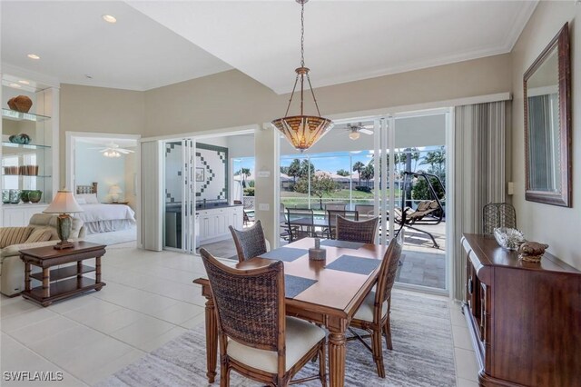 3774 Whidbey Way, Naples, FL 34119 - dining area featuring ceiling fan, light tile patterned floors, built in shelves, and crown molding