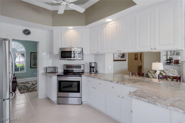 3774 Whidbey Way, Naples, FL 34119 - kitchen featuring appliances with stainless steel finishes, white cabinetry, light tile patterned flooring, and a towering ceiling