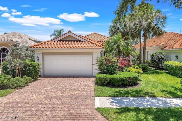 3774 Whidbey Way, Naples, FL 34119 - mediterranean / spanish-style house featuring stucco siding, decorative driveway, a tiled roof, a garage, and a front lawn