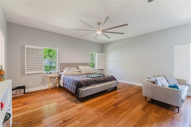 5208 Bygone St, Lehigh Acres, FL 33971 - bedroom with light wood-style flooring, baseboards, and a ceiling fan