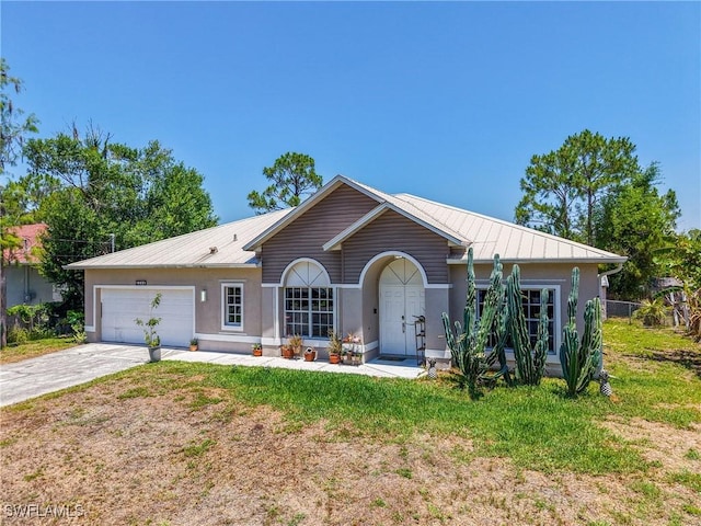 5208 Bygone St, Lehigh Acres, FL 33971 - ranch-style house with stucco siding, metal roof, a garage, driveway, and a front lawn