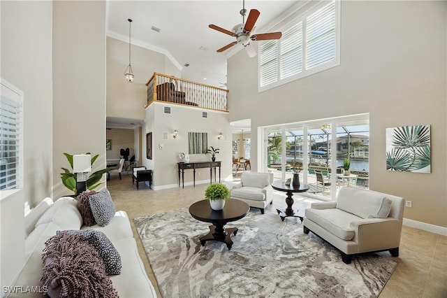 4013 Bastia Ct, Punta Gorda, FL 33950 - living area featuring a high ceiling, ceiling fan, tile patterned floors, plenty of natural light, and baseboards