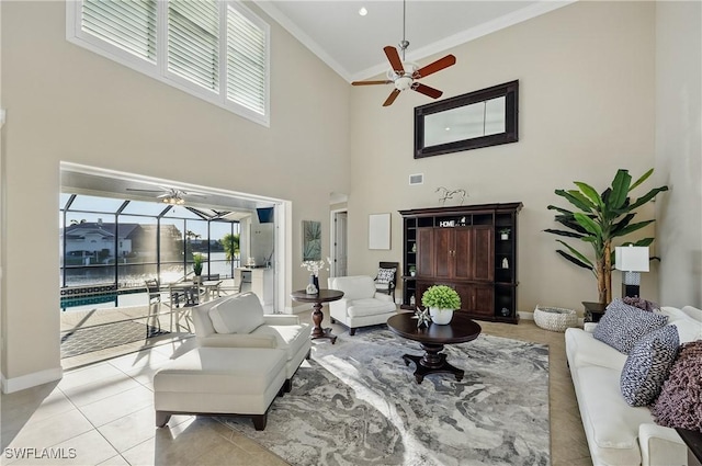 4013 Bastia Ct, Punta Gorda, FL 33950 - living room with ceiling fan, crown molding, a towering ceiling, baseboards, and a sunroom
