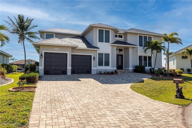 4013 Bastia Ct, Punta Gorda, FL 33950 - view of front of property with a garage, decorative driveway, a front lawn, and stucco siding