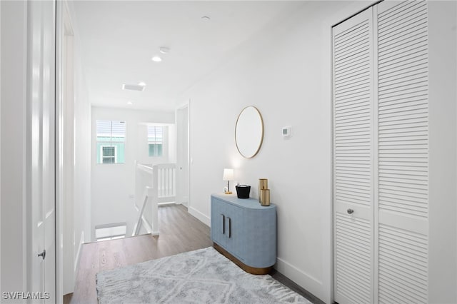 5851 Shell Cove Dr Unit 101A, Cape Coral, FL 33914 - hallway featuring an upstairs landing, wood finished floors, and baseboards