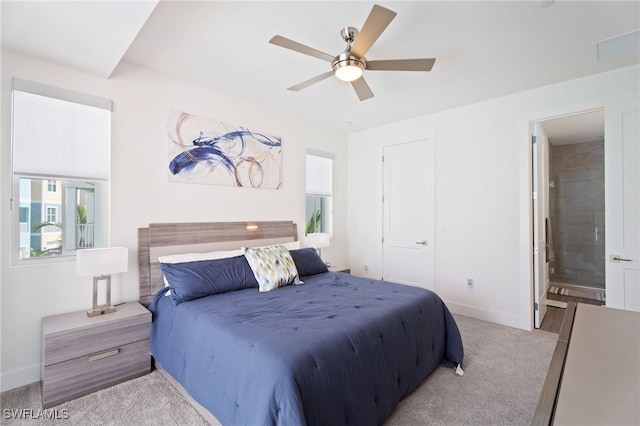 5851 Shell Cove Dr Unit 101A, Cape Coral, FL 33914 - carpeted bedroom with multiple windows, baseboards, ensuite bathroom, and ceiling fan