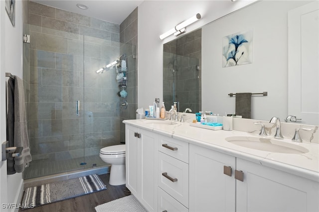 5851 Shell Cove Dr Unit 101A, Cape Coral, FL 33914 - full bathroom with a stall shower, double vanity, wood finished floors, and toilet