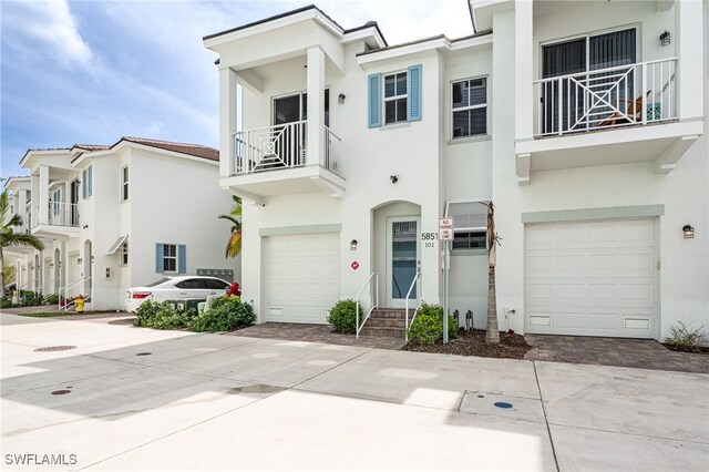 5851 Shell Cove Dr Unit 101A, Cape Coral, FL 33914 - multi unit property featuring an attached garage, stucco siding, a balcony, and decorative driveway