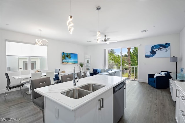 5851 Shell Cove Dr Unit 101A, Cape Coral, FL 33914 - kitchen featuring a sink, stainless steel dishwasher, open floor plan, and wood finished floors