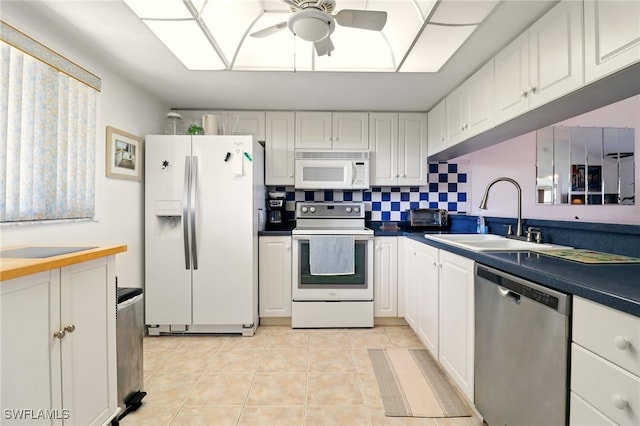 16000 Bay Pointe Blvd Unit 307, North Fort Myers, FL 33917 - kitchen with white appliances, a sink, ceiling fan, and white cabinets