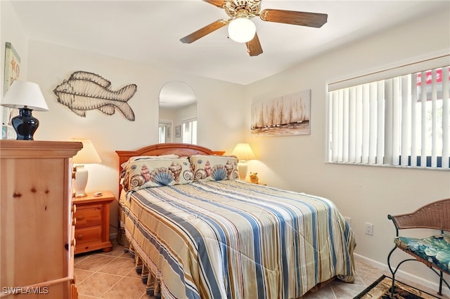 16000 Bay Pointe Blvd Unit 307, North Fort Myers, FL 33917 - bedroom featuring tile patterned floors, arched walkways, and a ceiling fan