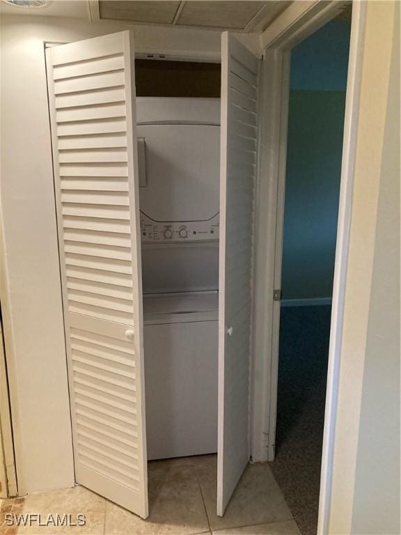 6300 S Pointe Blvd Unit 316, Fort Myers, FL 33919 - washroom with stacked washing machine and dryer and light tile patterned floors