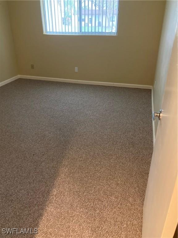 6300 S Pointe Blvd Unit 316, Fort Myers, FL 33919 - spare room with plenty of natural light, carpet, and baseboards