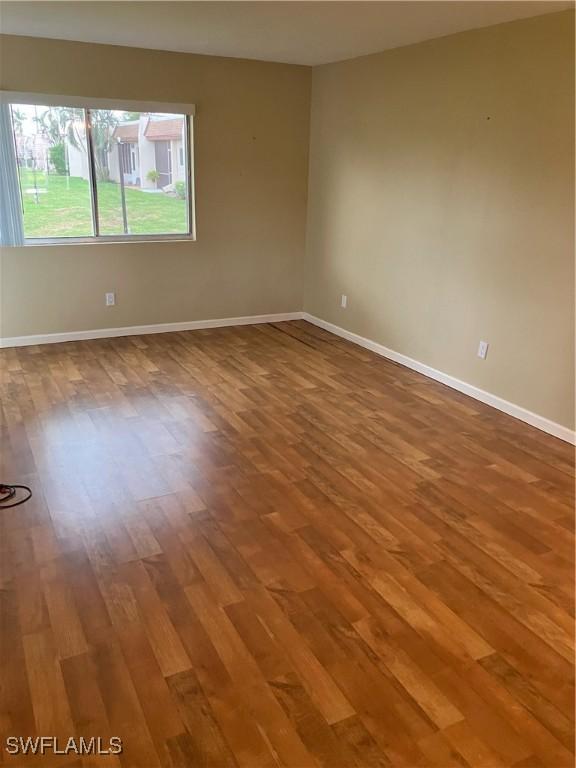 6300 S Pointe Blvd Unit 316, Fort Myers, FL 33919 - empty room with wood finished floors and baseboards