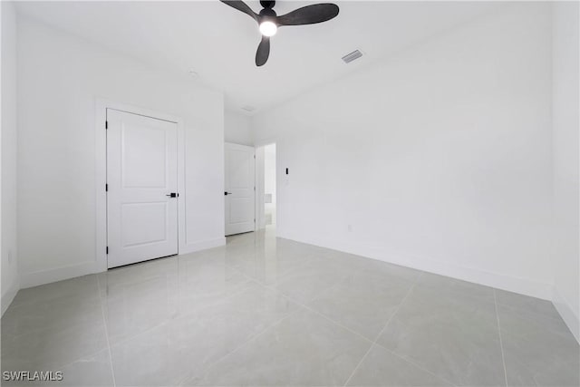 619 Greenbriar Blvd, Lehigh Acres, FL 33972 - empty room with ceiling fan, light tile patterned floors, and baseboards