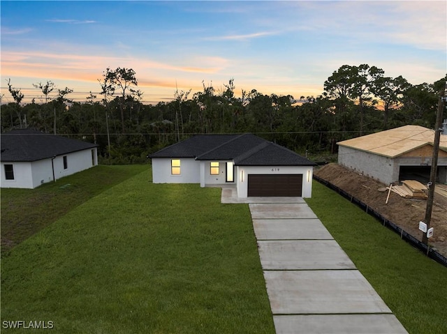 619 Greenbriar Blvd, Lehigh Acres, FL 33972 - view of front facade featuring a front lawn, concrete driveway, and an attached garage